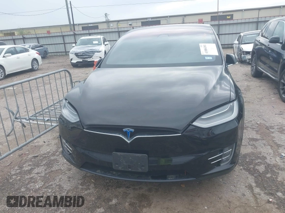 2021 Tesla Model X Long Range Plus with VIN 5YJXCAE27MF324270, listed as a IAAI auction lot 41886101 with 59,614 mi miles and . Bid and sale history available at carsss.com. Image 12.