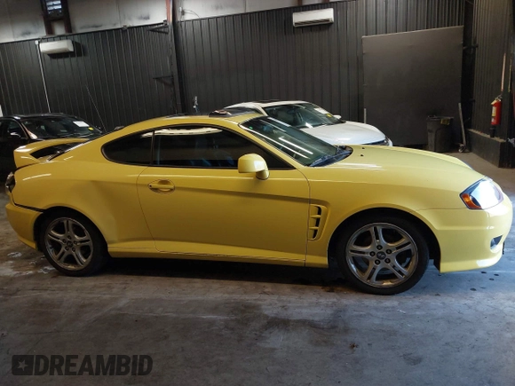 2006 Hyundai Tiburon GT z VIN KMHHN65F56U225936, wystawiony jako IAAI lot #41695280 z przebiegiem 121 110 mil mil oraz . Historia ofert i sprzedaży dostępna na DreamBid. Obrazek 13.
