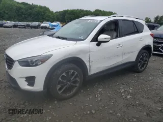 2016 Mazda CX-5 Grand Touring z VIN JM3KE4DY4G0696395, wystawiony jako Copart lot #59782575 z przebiegiem 127 244 mil mil oraz Szkoda całkowita • Salvage title. Historia ofert i sprzedaży dostępna na DreamBid. Obrazek 1.