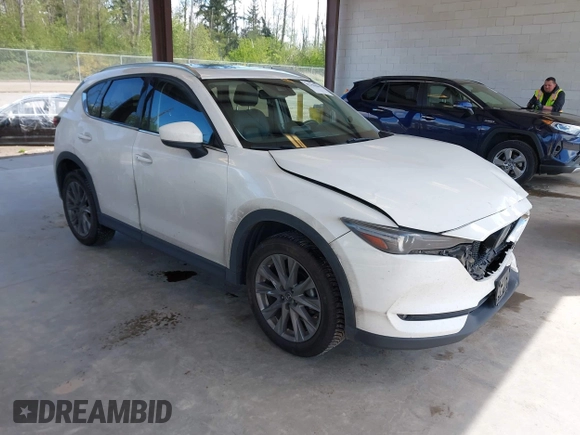 2020 Mazda CX-5 Grand Touring with VIN JM3KFBDM2L0863944, listed as a IAAI auction lot 42150805 with 63,932 mi miles and . Bid and sale history available at DreamBid. Image 1.
