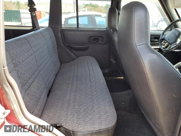 1999 Jeep Cherokee Sport z VIN 1J4FF68S7XL590900, wystawiony jako Copart lot #55098635 z przebiegiem 265 588 mil mil oraz Szkoda całkowita • Salvage title. Historia ofert i sprzedaży dostępna na DreamBid. Obrazek 11.