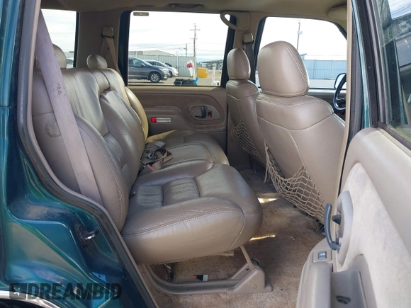 1999 GMC Yukon with VIN 1GKEK13R3XJ717999, listed as a IAAI auction lot 41870187 with 179,855 mi miles. Bid and sale history available at carsss.com. Image 8.