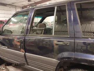 1997 Jeep Grand Cherokee Laredo with VIN 1J4GZ58S8VC675487, listed as a IAAI auction lot 41034046 with 243,284 mi miles. Bid and sale history available at carsss.com. Image 14.