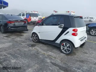 2013 Smart fortwo Pure with VIN WMEEJ3BA9DK631660, listed as a IAAI auction lot 41917570 with 65,890 mi miles. Bid and sale history available at carsss.com. Image 3.