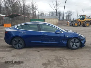 2019 Tesla Model 3 Mid Range with VIN 5YJ3E1EA5KF299589, listed as a IAAI auction lot 41709733 with 50,256 mi miles and . Bid and sale history available at DreamBid. Image 14.