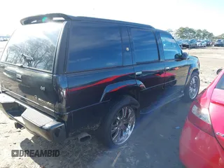 1999 Cadillac Escalade z VIN 1GYEK13R4XR411823, wystawiony jako IAAI lot #41221246 z przebiegiem 184 123 mil mil oraz . Historia ofert i sprzedaży dostępna na DreamBid. Obrazek 4.