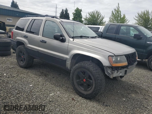 2000 Jeep Grand Cherokee Laredo with VIN 1J4GW48S9YC390448, listed as a Copart auction lot 56985265 with Not provided miles and Salvage title. Bid and sale history available at DreamBid. Image 4.