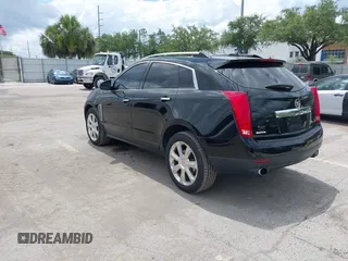 2015 Cadillac SRX Performance Collection z VIN 3GYFNCE31FS597798, wystawiony jako IAAI lot #42387793 z przebiegiem 159 986 mil mil oraz . Historia ofert i sprzedaży dostępna na DreamBid. Obrazek 3.