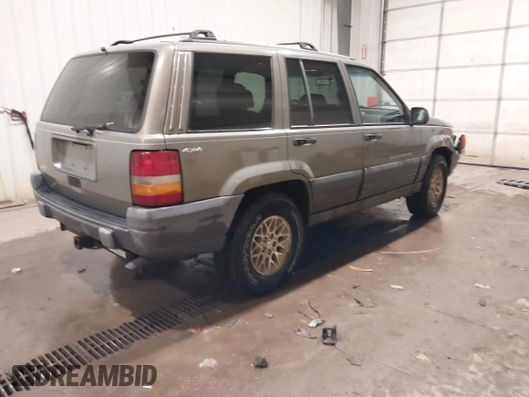 1996 Jeep Grand Cherokee Laredo with VIN 1J4GZ58S5TC182766, listed as a IAAI auction lot 41372356 with 234,390 mi miles. Bid and sale history available at carsss.com. Image 4.