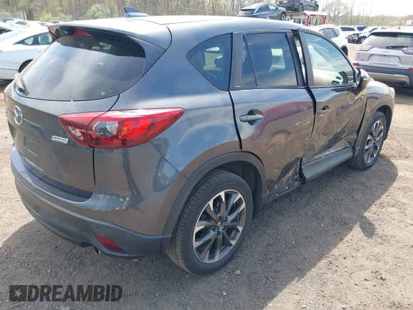 2016 Mazda CX-5 Grand Touring z VIN JM3KE4DY1G0893119, wystawiony jako IAAI lot #42049614 z przebiegiem 102 506 mil mil oraz . Historia ofert i sprzedaży dostępna na DreamBid. Obrazek 4.