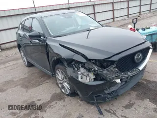 2020 Mazda CX-5 Grand Touring with VIN JM3KFADM8L0811910, listed as a IAAI auction lot 41446214 with 57,849 mi miles. Bid and sale history available at carsss.com. Image 1.