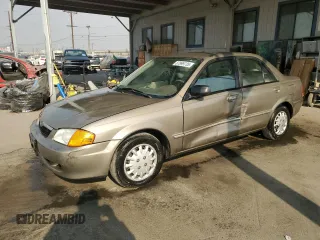 1999 Mazda Protege DX with VIN JM1BJ2223X0137153, listed as a Copart auction lot 87899735 with 154,209 mi miles and Salvage Title. Bid and sale history available at DreamBid. Image 1.