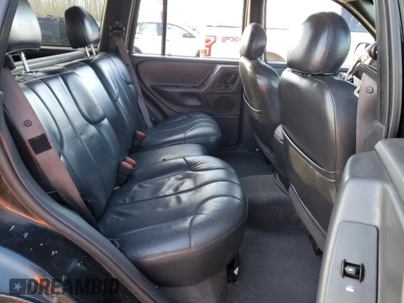 1999 Jeep Grand Cherokee Laredo z VIN 1J4GW58N1XC737706, wystawiony jako Copart lot #83107914 z przebiegiem Nie podano mil oraz Szkoda całkowita • Salvage title. Historia ofert i sprzedaży dostępna na DreamBid. Obrazek 12.