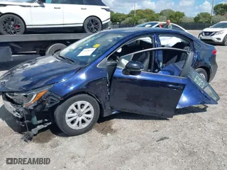 2020 Toyota Corolla Hybrid LE with VIN JTDEBRBE8LJ031556, listed as a IAAI auction lot 41576129 with 103,989 mi miles. Bid and sale history available at carsss.com. Image 2.