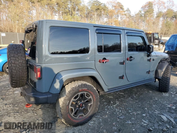2015 Jeep Wrangler Unlimited Rubicon Hard Rock with VIN 1C4HJWFGXFL671660, listed as a Copart auction lot 82329074 with 214,579 mi miles and Salvage title. Bid and sale history available at DreamBid. Image 3.