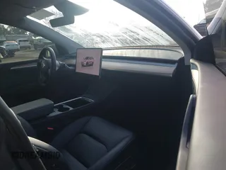 2023 Tesla Model Y Long Range with VIN 7SAYGDEE7PA196038, listed as a IAAI auction lot 41459601 with 16,489 mi miles and . Bid and sale history available at DreamBid. Image 5.