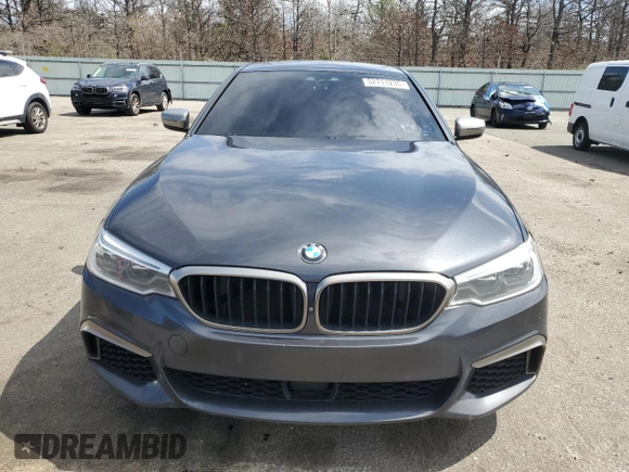 2018 BMW 5 Series M550i xDrive with VIN WBAJB9C57JB286734, listed as a Copart auction lot 52711235 with 127,450 mi miles and Salvage title. Bid and sale history available at DreamBid. Image 5.