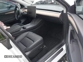 2023 Tesla Model Y Long Range with VIN 7SAYGDEE7PF809164, listed as a IAAI auction lot 41828974 with 31,772 mi miles. Bid and sale history available at carsss.com. Image 5.