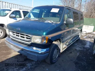 1999 Ford Econoline Cargo with VIN 1FDRE14W3XHB36482, listed as a IAAI auction lot 41393346 with 130,669 mi miles. Bid and sale history available at carsss.com. Image 2.