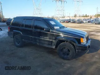 1996 Jeep Grand Cherokee Laredo with VIN 1J4GZ58S3TC197587, listed as a IAAI auction lot 41423318 with 200,116 mi miles. Bid and sale history available at carsss.com. Image 1.