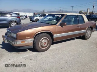 1988 Cadillac Eldorado with VIN 1G6EL115XJU611177, listed as a Copart auction lot 46526855 with 122,780 mi miles and Salvage Title. Bid and sale history available at DreamBid. Image 1.