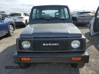 1986 Suzuki Samurai z VIN JS3JC51V8G4110639, wystawiony jako Copart lot #75466894 z przebiegiem Nie podano mil oraz Szkody całkowita. Historia ofert i sprzedaży dostępna na DreamBid. Obrazek 5.