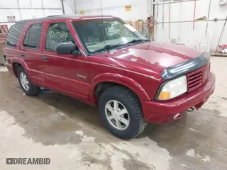 1999 Oldsmobile Bravada with VIN 1GHDT13W9X2701952, listed as a IAAI auction lot 42093184 with 121,532 mi miles. Bid and sale history available at carsss.com. Image 1.