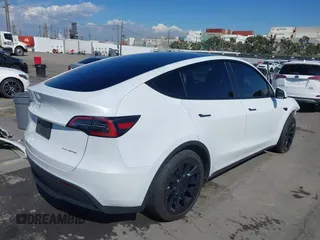 2023 Tesla Model Y Long Range with VIN 7SAYGDEEXPA129790, listed as a IAAI auction lot 41735721 with 20,402 mi miles and . Bid and sale history available at DreamBid. Image 4.