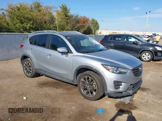 2016 Mazda CX-5 Grand Touring z VIN JM3KE2DY3G0712249, wystawiony jako IAAI lot #37910910 z przebiegiem 262 058 mil mil oraz . Historia ofert i sprzedaży dostępna na DreamBid. Obrazek 1.