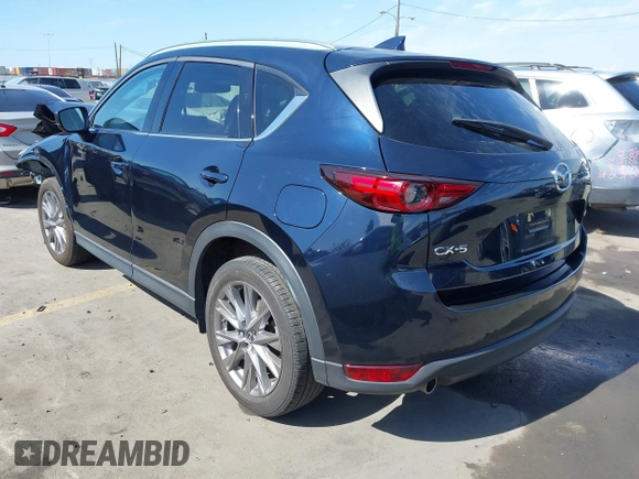 2020 Mazda CX-5 Grand Touring with VIN JM3KFADM6L1830093, listed as a IAAI auction lot 41699672 with 66,769 mi miles. Bid and sale history available at carsss.com. Image 3.