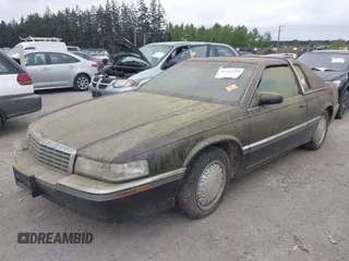 1992 Cadillac Eldorado z VIN 1G6EL13B0NU605624, wystawiony jako IAAI lot #42127549 z przebiegiem Nie podano mil oraz . Historia ofert i sprzedaży dostępna na DreamBid. Obrazek 2.