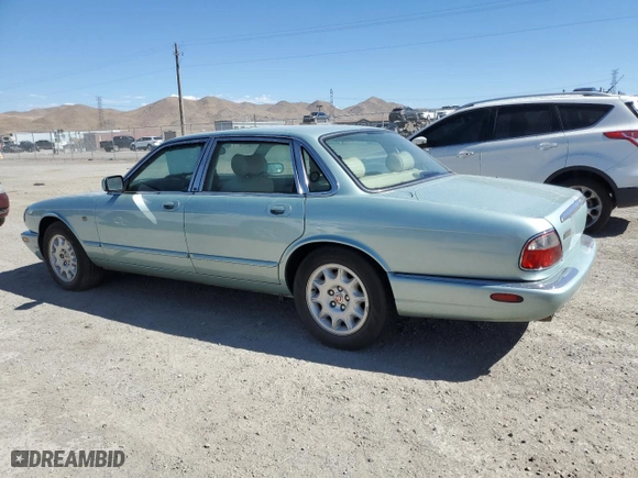 2000 Jaguar XJ with VIN SAJDA14C1YLF10459, listed as a Copart auction lot 65583394 with 113,333 mi miles and Salvage Title. Bid and sale history available at carsss.com. Image 2.