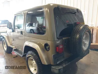 2003 Jeep Wrangler Sahara z VIN 1J4FA59S83P343234, wystawiony jako IAAI lot #41644074 z przebiegiem 197 461 mil mil oraz . Historia ofert i sprzedaży dostępna na DreamBid. Obrazek 3.