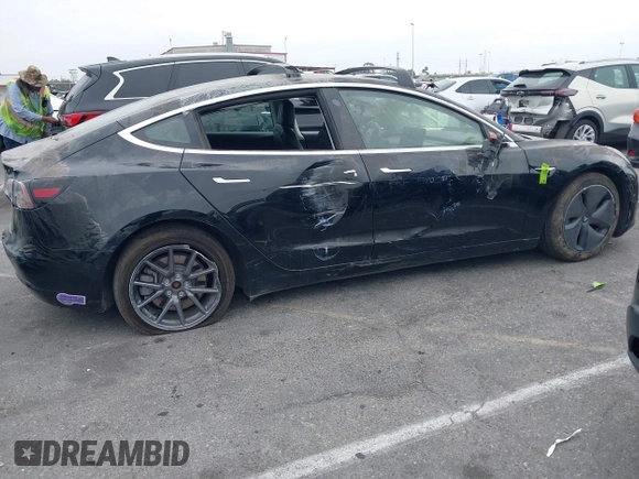 2019 Tesla Model 3 Mid Range with VIN 5YJ3E1EA2KF362048, listed as a IAAI auction lot 40141734 with 70,321 mi miles and . Bid and sale history available at carsss.com. Image 12.