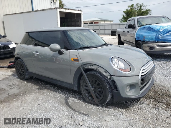 2014 MINI Hardtop with VIN WMWXM5C51ET934047, listed as a Copart auction lot 63039335 with 104,446 mi miles and Salvage title. Bid and sale history available at DreamBid. Image 4.