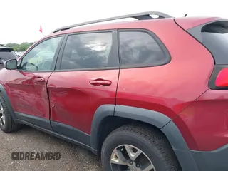 2015 Jeep Cherokee Trailhawk with VIN 1C4PJMBS6FW575517, listed as a IAAI auction lot 42661199 with 299,166 mi miles and . Bid and sale history available at DreamBid. Image 14.