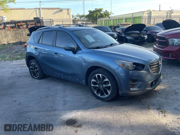 2016 Mazda CX-5 Grand Touring with VIN JM3KE4DY9G0673789, listed as a IAAI auction lot 42196841 with 98,622 mi miles and . Bid and sale history available at DreamBid. Image 1.