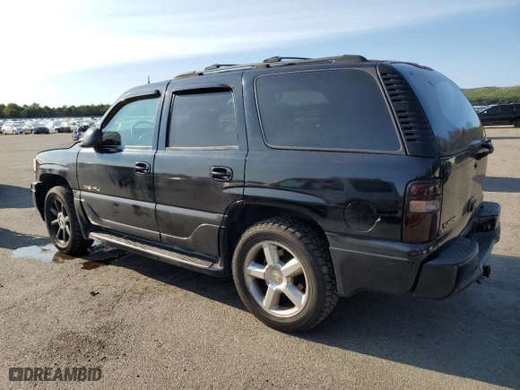 2004 GMC Yukon Denali with VIN 1GKEK63U74J212674, listed as a Copart auction lot 69704734 with 174,893 mi miles and Salvage Title. Bid and sale history available at carsss.com. Image 2.