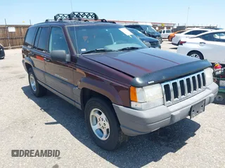 1996 Jeep Grand Cherokee Laredo z VIN 1J4GZ58Y2TC354076, wystawiony jako IAAI lot #42572842 z przebiegiem 172 282 mil mil oraz . Historia ofert i sprzedaży dostępna na DreamBid. Obrazek 1.