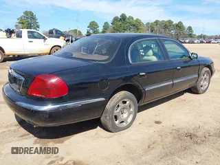 1999 Lincoln Continental with VIN 1LNHM97V8XY686521, listed as a IAAI auction lot 41681027 with 144,407 mi miles. Bid and sale history available at carsss.com. Image 4.