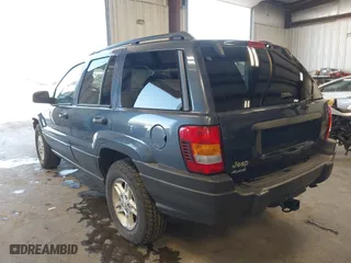 2003 Jeep Grand Cherokee Laredo with VIN 1J4GW48S33C539977, listed as a IAAI auction lot 42027703 with 100,534 mi miles. Bid and sale history available at carsss.com. Image 3.