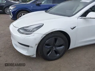 2020 Tesla Model 3 Standard Range Plus with VIN 5YJ3E1EA5LF613002, listed as a IAAI auction lot 42129085 with 55,672 mi miles. Bid and sale history available at carsss.com. Image 6.