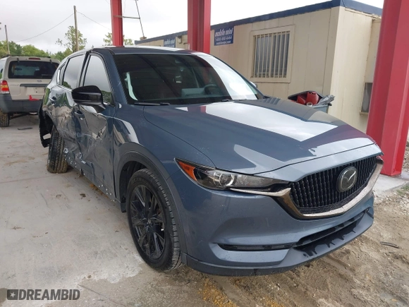 2021 Mazda CX-5 Touring with VIN JM3KFACM0M0327832, listed as a IAAI auction lot 41989199 with 42,396 mi miles. Bid and sale history available at carsss.com. Image 1.