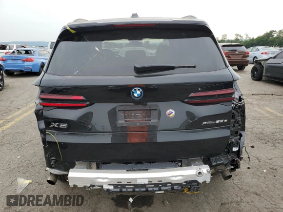 2024 BMW X5 xDrive50e with VIN 5UX43EU02R9U91727, listed as a Copart auction lot 64155574 with 7,050 mi miles and Salvage Title. Bid and sale history available at carsss.com. Image 6.
