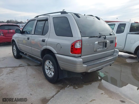 2004 Isuzu Rodeo S with VIN 4S2CK58W344311048, listed as a IAAI auction lot 41472392 with 128,732 mi miles. Bid and sale history available at carsss.com. Image 3.