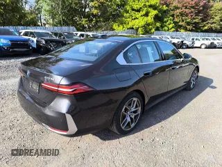 2024 BMW i5 eDrive40 with VIN WBY33FK05RCR58520, listed as a Copart auction lot 77179704 with 16 mi miles and Salvage Title. Bid and sale history available at carsss.com. Image 4.