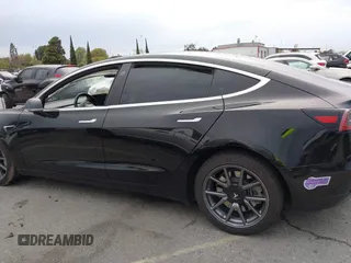2019 Tesla Model 3 Mid Range with VIN 5YJ3E1EA6KF361808, listed as a IAAI auction lot 41767241 with 96,200 mi miles and . Bid and sale history available at carsss.com. Image 14.
