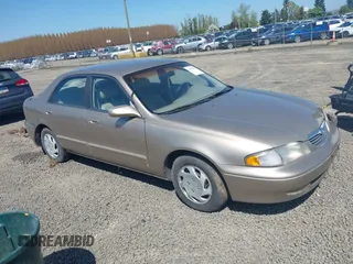 1999 Mazda 626 ES z VIN 1YVGF22C5X5811946, wystawiony jako IAAI lot #41970165 z przebiegiem 126 709 mil mil oraz . Historia ofert i sprzedaży dostępna na DreamBid. Obrazek 1.