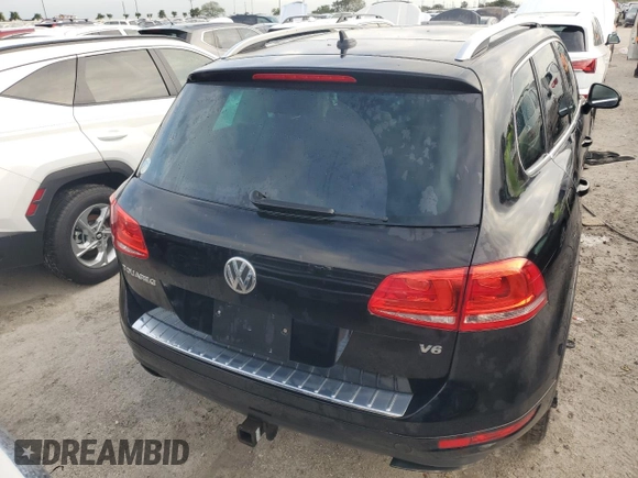 2012 Volkswagen Touareg Exec with VIN WVGEF9BP1CD011407, listed as a Copart auction lot 79199754 with 57,376 mi miles and Salvage Title. Bid and sale history available at DreamBid. Image 6.