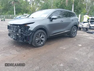 2023 Kia Sportage SX-Prestige with VIN KNDPXCAG7P7071365, listed as a IAAI auction lot 42247639 with 21,509 mi miles and . Bid and sale history available at DreamBid. Image 2.